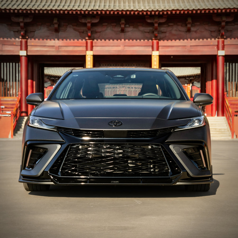 Head-on view of a grey 2025-2026 Toyota Camry with the YOFER front
bumper, showing the full-width mesh grille and both corner intakes