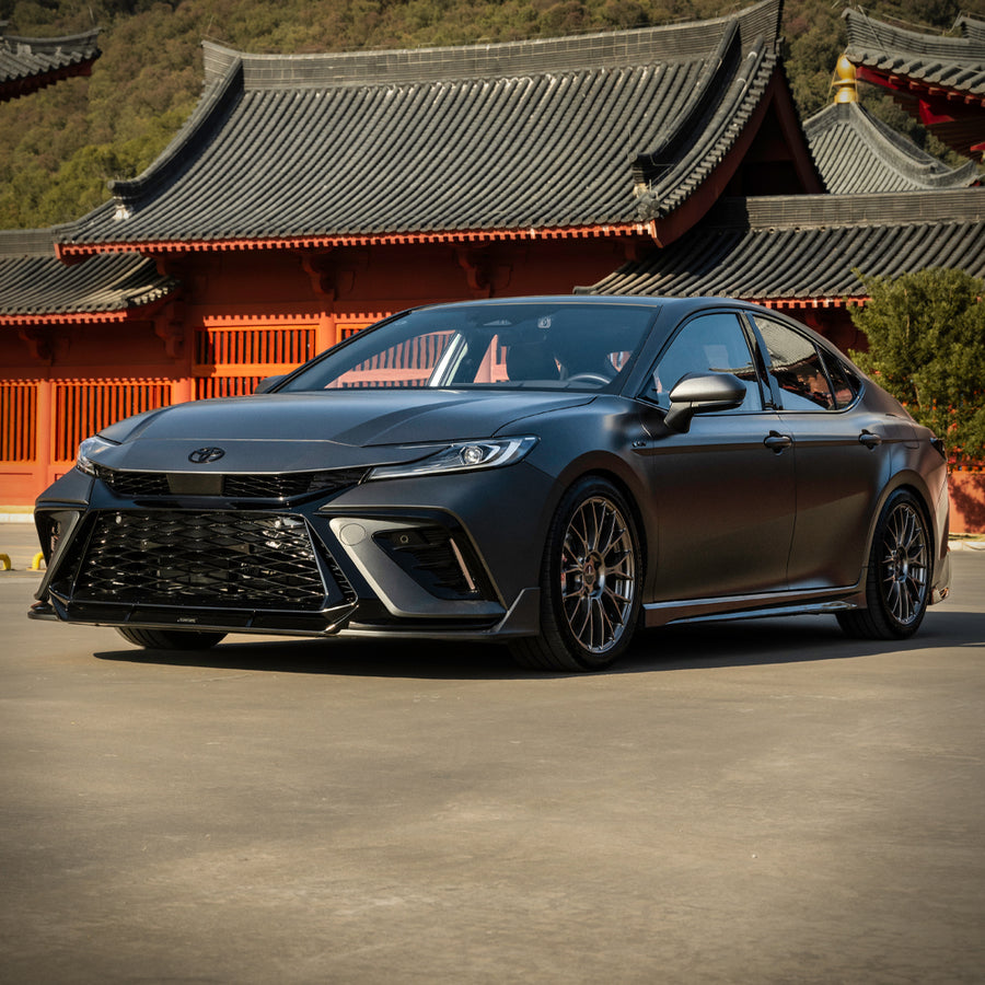 Grey 2025-2026 Toyota Camry with the YOFER front bumper, passenger-side
three-quarter view showing the front lip and full profile