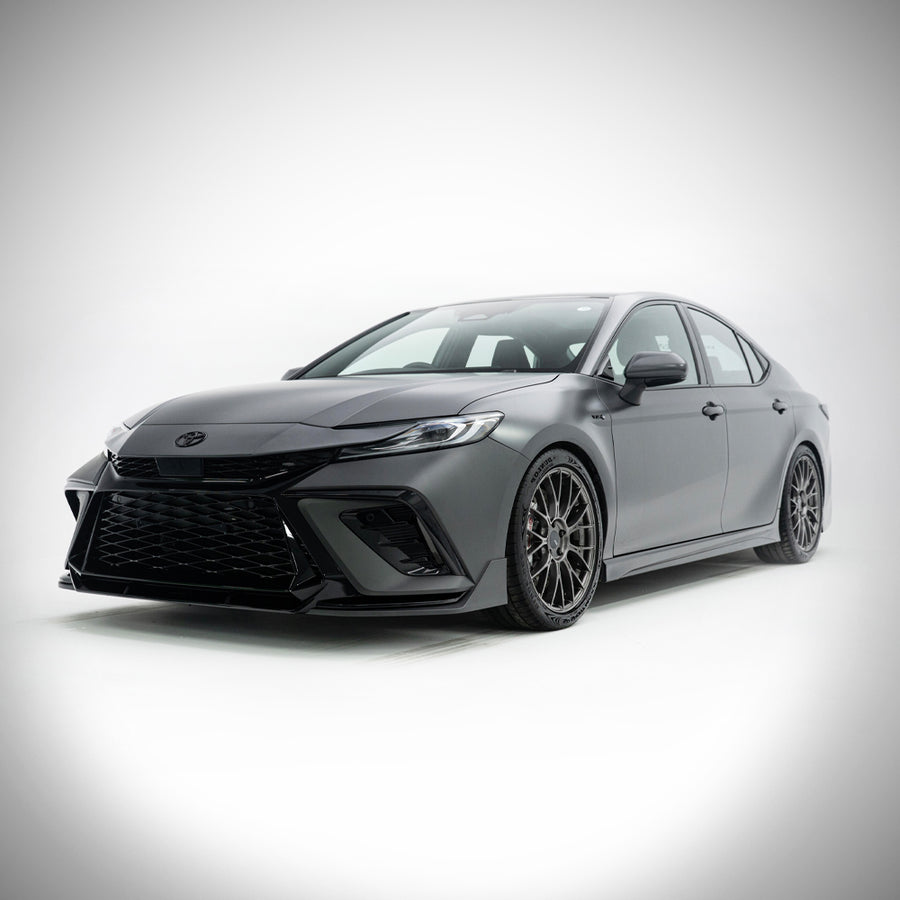 Grey 2025-2026 Toyota Camry with the YOFER front bumper, driver-side
three-quarter studio view on a white background